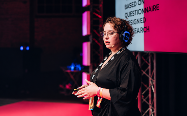 Magenta-Lit Speaker on Stage
